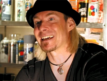erik wahl smiling with spray paints in the background