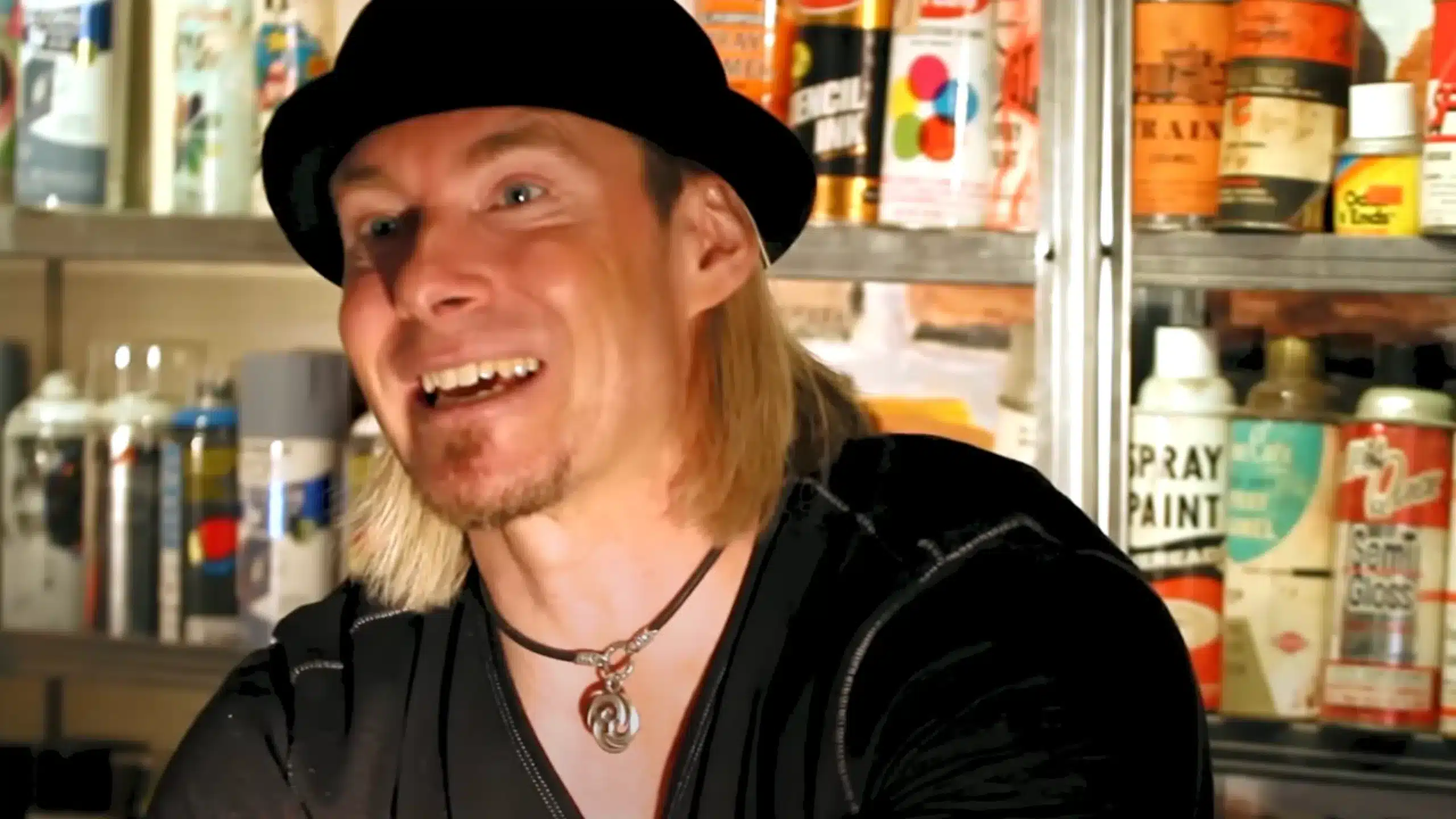 erik wahl smiling with spray paints in the background