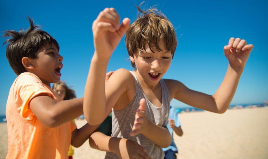 Close-up of ecstatic preteen boy friends laughing