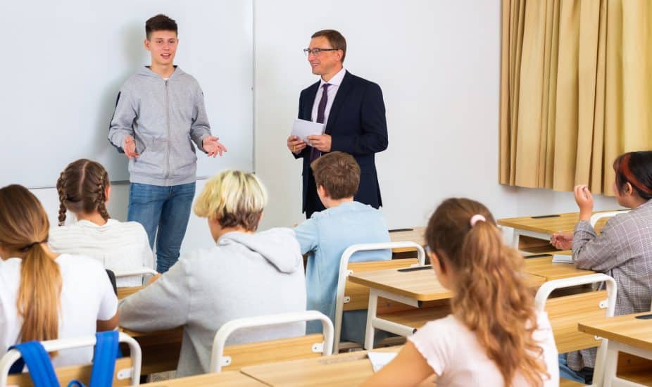 Teen boy answering at board at classroom