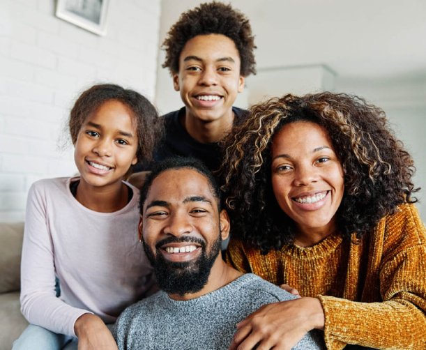 Family of four smiling